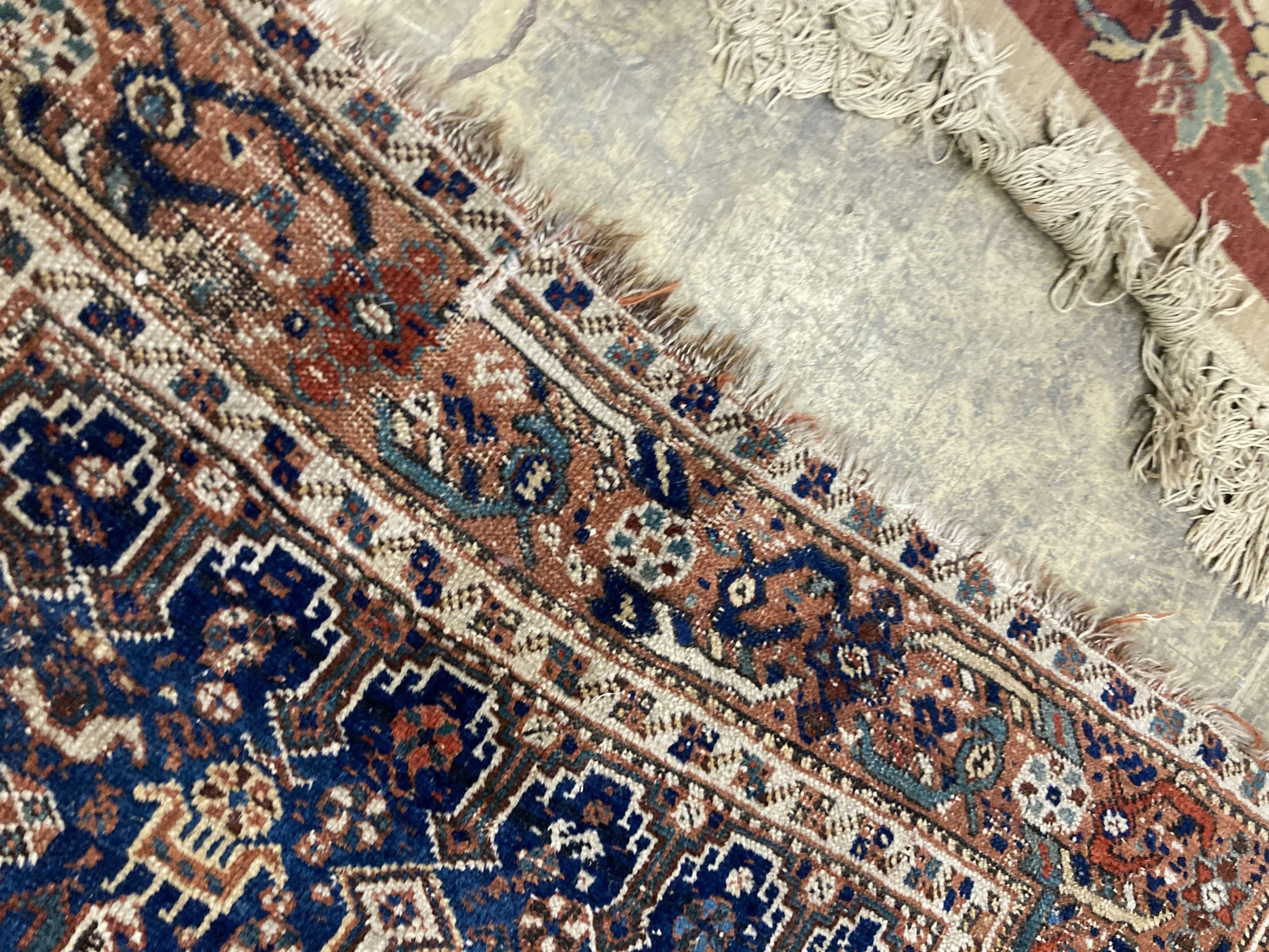 Three antique Caucasian blue ground rugs, largest 154 x 114 cms.